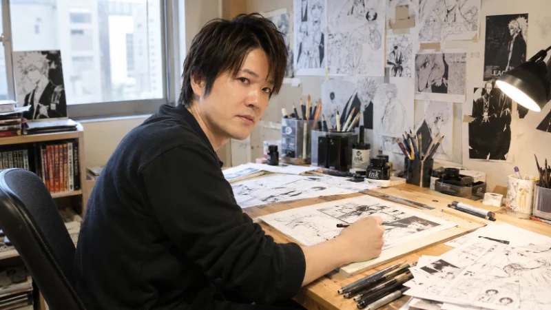 Tite Kubo working at his drafting desk early in his manga career